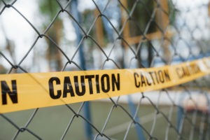 Property Crime Lawyer in Ridgecrest | Free Consultations 24/7 caution tape on a fence