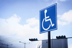 A symbol of a wheelchair user is used to indicate a parking space reserved for blue badge holders. California Vehicle Code Section 4461 addresses the unlawful use of a disability placard.