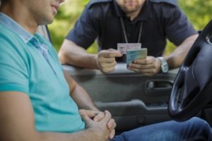 California Vehicle Codes | What to Know a police officer looks at a driver's identification