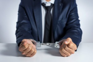 businessperson in handcuffs