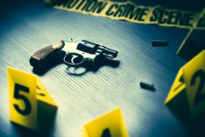 Crime scene with a gun and bullets on the floor 