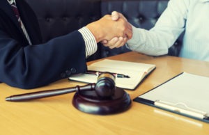lawyer shakes hands with client