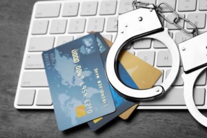Identity Theft Lawyer in Los Angeles | Free Consultations 24/7 Handcuffs and credit cards on a computer keyboard