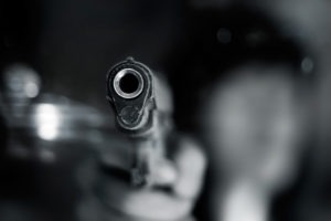 Aggravated Assault With a Firearm Defense Lawyer in Los Angeles, CA an assailant menacingly pointing a gun