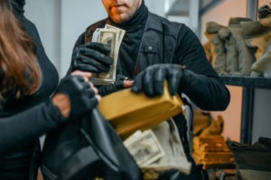 Bank Robbery Lawyer in Los Angeles | Free Consultations 24/7 bank robbers loading cash and gold into a bag