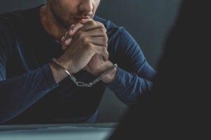 Child Molestation Lawyer in Los Angeles | Free Consultations 24/7 handcuffed-suspect-in-interrogation room