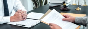 Los Angeles Statutory Rape Defense Lawyers | Simmrin Law Group lawyer reviewing paperwork with client