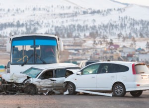 two cars and a bus involved in an accident