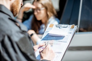 Traffic Violation Lawyer in Lakewood | Free Consultations 24/7 Police officer issuing a traffic violation to a female driver