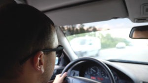 man in sunglasses driving