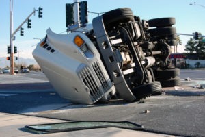Truck Accident Lawyer in Los Angeles, CA | Simmrin Law Group a semi truck rolled over on its side after an accident