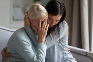 woman embracing distraught mother
