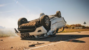 a rolled over vehicle in the middle of the road after an accident