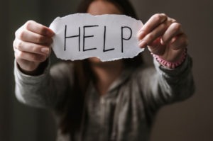 Domestic Violence Lawyer in Glendale | Free Consult girl holding a help sign