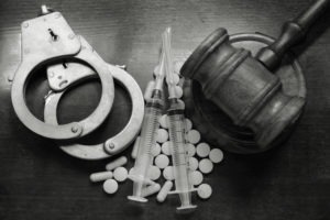Drug Crimes Lawyers in Alhambra | Call 24/7 | Simmrin Law Image of drugs together with handcuffs and gavel.