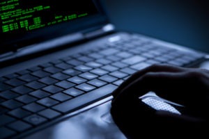 hacker using laptop to steal information