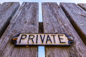 Property Crime Lawyer in Irvine | Free Consultations 24/7 private sign on a fence
