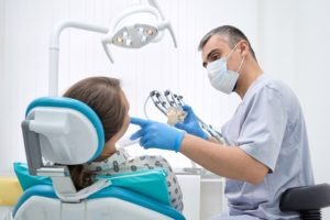 dentist helping patient