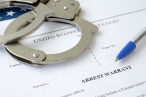 arrest warrant with handcuffs