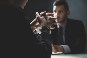 DUI Lawyer in East Hollywood | Free Consultations criminal man in handcuffs being interviewed