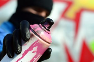 Property Crimes Lawyer in Chino | Free Consultations man about to use spray paint