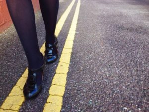 woman-walking-on-yellow-street-lines-for-sobriety
