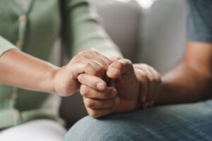 female doctor holding patient’s hand