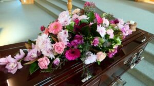 Wrongful Death Lawyer in Long Beach | Free Consultations 24/7 casket with flowers