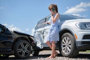 Car Accident Lawyer in San Diego | Free Consultations 24/7 female driver talking on phone at crash site