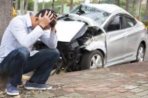 Car Accident Lawyer in Irvine | Free Consultations 24/7 upset-driver-with-car-smashed-into-tree