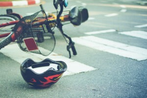 Bicycle Accident Lawyer in West Covina | Free Consultations 24/7 helmet and bike in road