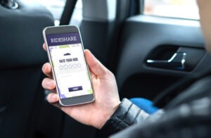 Rideshare Accident Lawyer in Downey | Free Consultations 24/7 person using rideshare app in car