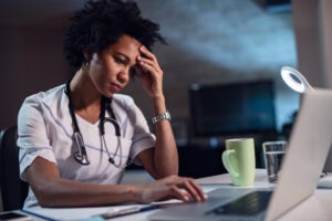 Medical Malpractice Lawyer in Irvine | Free Consultations 24/7 stressed black nurse on computer