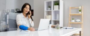 injured woman on the phone with workers comp