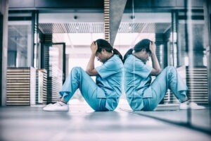 Medical Malpractice Lawyer in San Diego | Free Consultations 24/7 stressed nurse sitting on floor