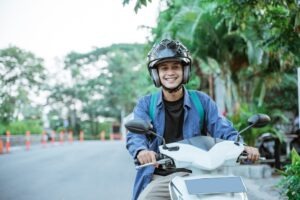 Motorcycle Accident Lawyer in Gardena | Free Consultations 24/7 A man rides a motorcycle with a helmet on. Contact a Gardena motorcycle accident lawyer now.