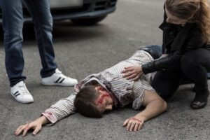 Pedestrian Accident Lawyer in Gardena | Free Consultations 24/7 A man lying injured after a pedestrian accident. Get medical help, and then call our Gardena pedestrian accident lawyers for advice.