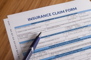 Insurance claim form on the table after a Los Angeles car accident.