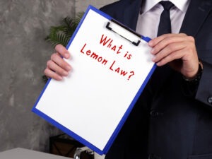 A lawyer holding a Lemon Law sign. Find out more about California’s Lemon Law today.