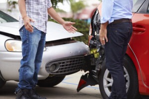 Two men after a car accident. You can discuss going to court for a car accident case with our legal team.