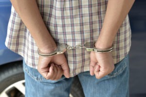 Self-Defense or Provocation in Assault Cases | Free Consultation a man in handcuffs after being arrested for assault