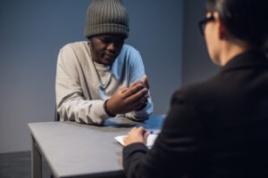 A man speaking with a criminal defense lawyer after being falsely accused of rape.