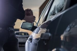 If the owner of this black car shoots the person trying to break into their car in California, they will likely face charges.