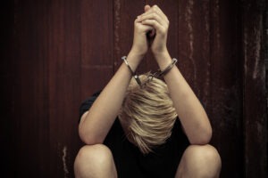A juvenile is in handcuffs after being charged for assault and battery in California. A juvenile criminal defense lawyer can provide compassionate legal representation.
