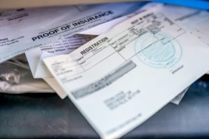 The photo shows a car’s registration papers. Review California Vehicle Code Section 4463: Forging or Falsifying Vehicle Registration.