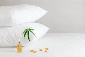 CBD products next to a pillow. CBD sleep concept. Does CBD make you sleepy?